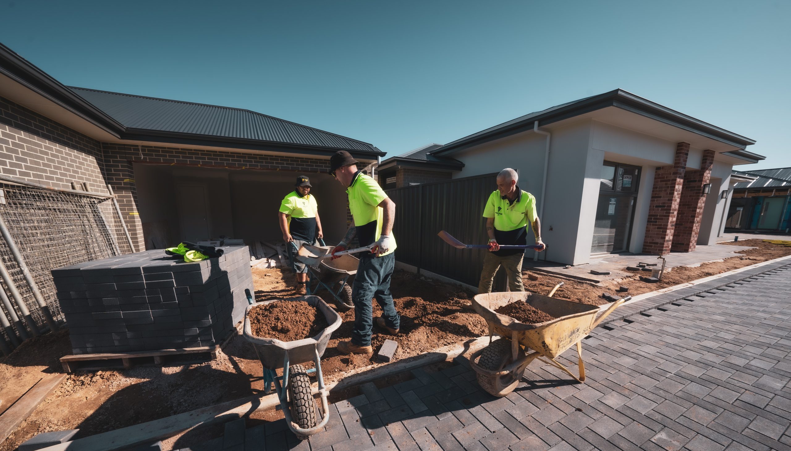 paving contractors shovelling dirt