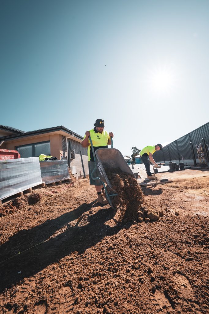 paving contractor in adelaide tipping out dirt in a wheelbarrow