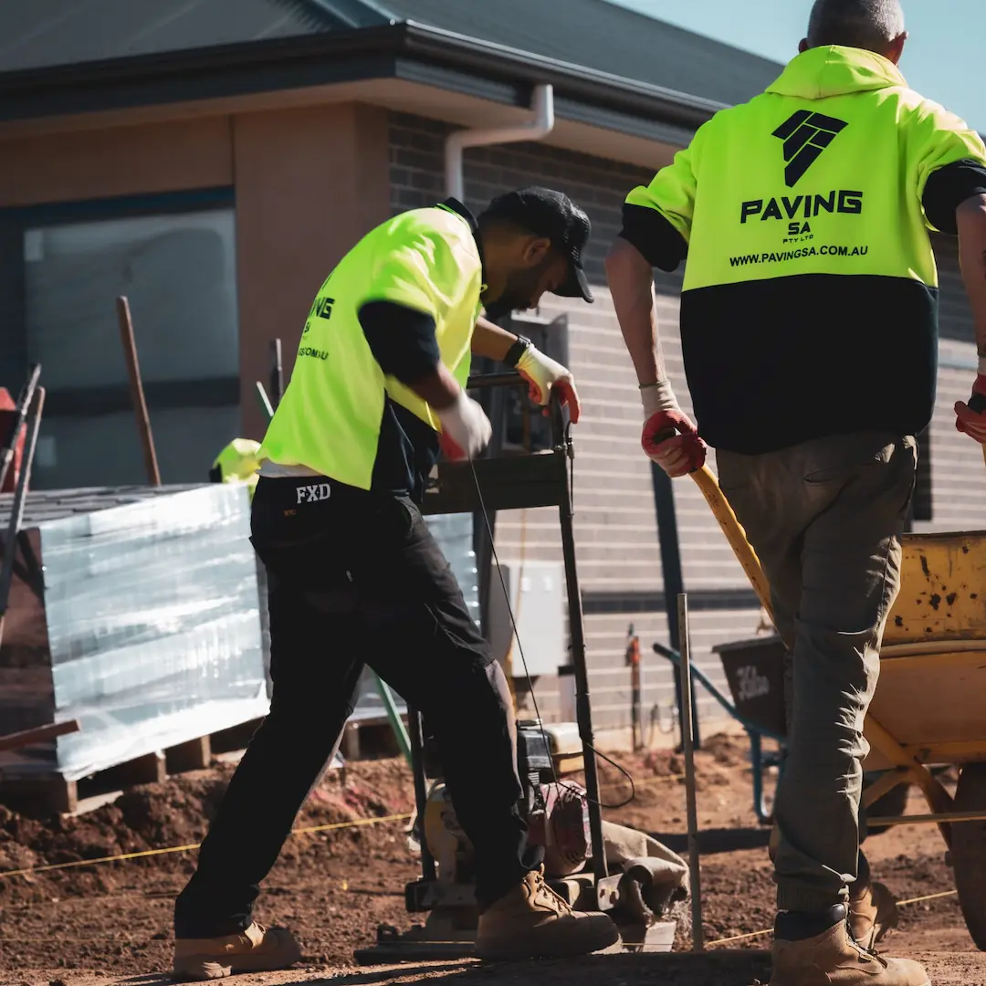 Two tradesman operating equipment on a paving site in Adelaide