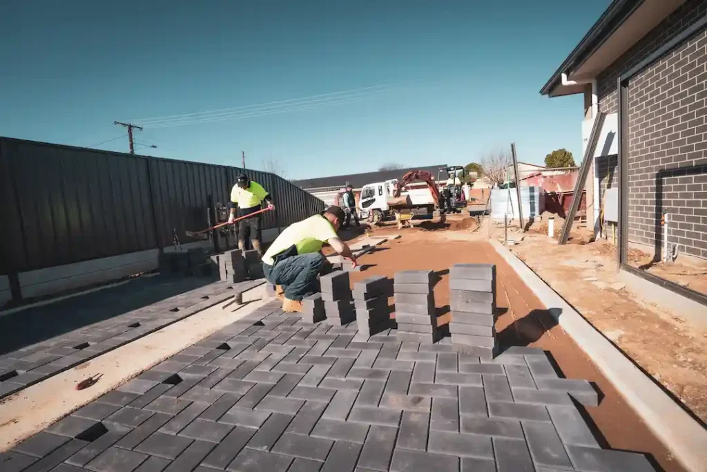 paving contractors laying brick paving stones